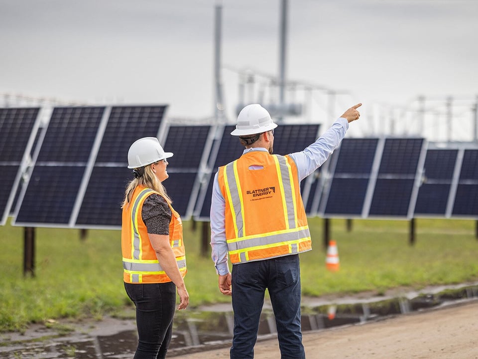 Blattner employee showing client progress in solar field