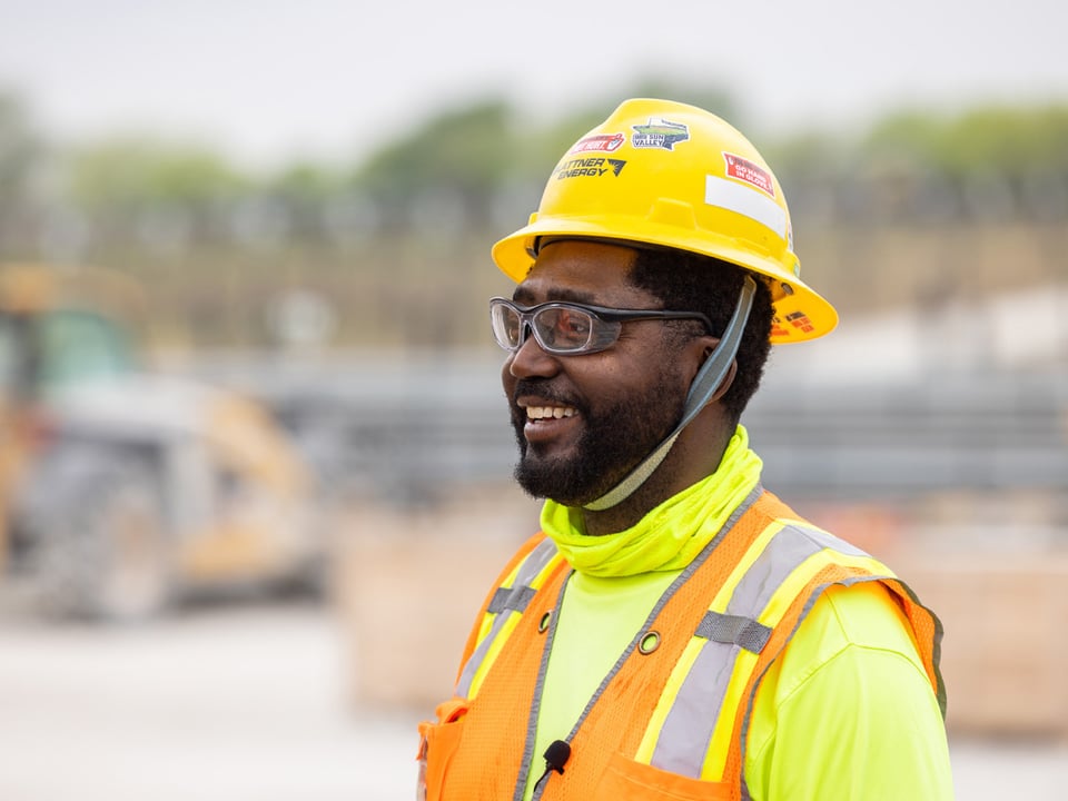 Close up of smiling African American male employee on a solar array