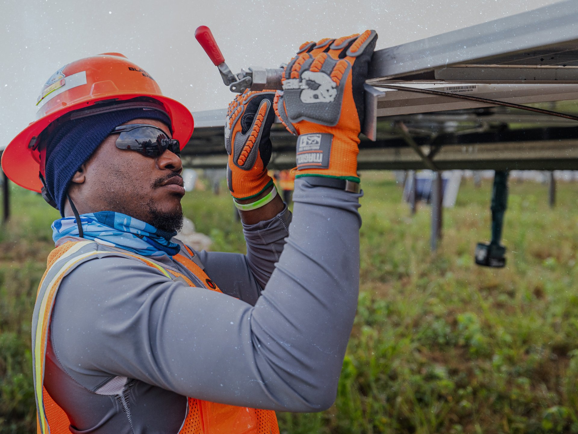 Construction worker installing solar panels