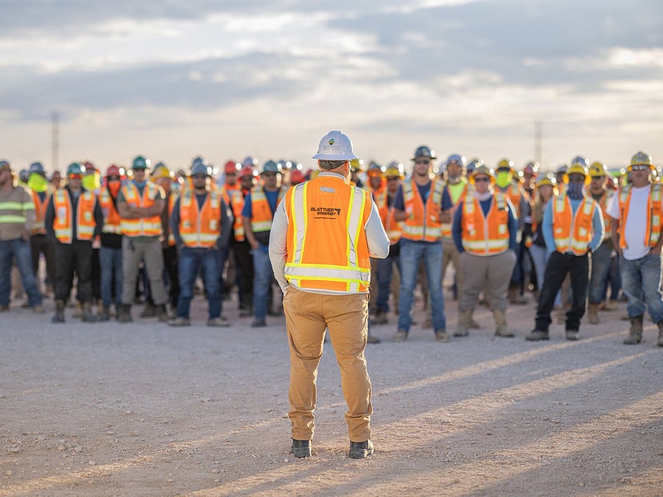 View of site leaders back as he talks to the site team who is facing him