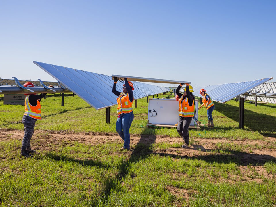 Workers installing solar panels